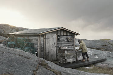 Man near fishing shed - JOHF03553