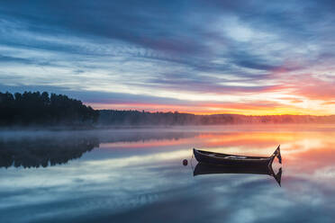 Boat in lake at sunrise - JOHF03607