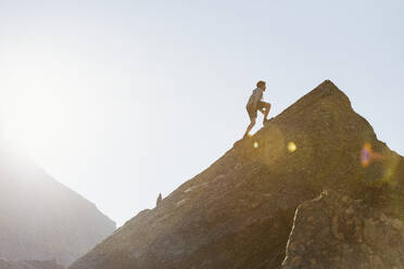 Boy climbing mountain - JOHF03637