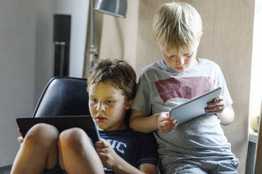 Boys using digital tablets - JOHF03687