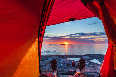 Man in tent at sunset - JOHF03808