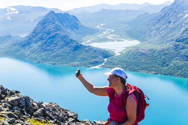 Woman taking selfie in mountains - JOHF04002