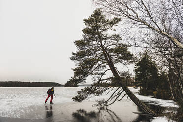 Ice skater on frozen lake - JOHF04053