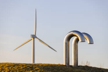 Pipes, wind turbine on background - JOHF04130