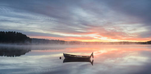 Boat in lake at sunrise - JOHF04181