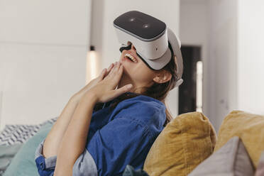 Young woman using VR glasses at home - MFF04875