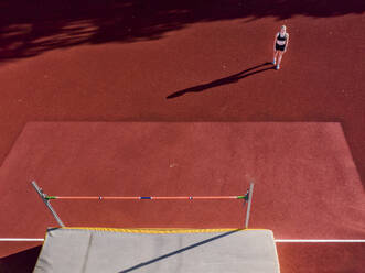 Germany, Baden-Wurttemberg, Schorndorf, Female athlete concentrating before high jump - STSF02288