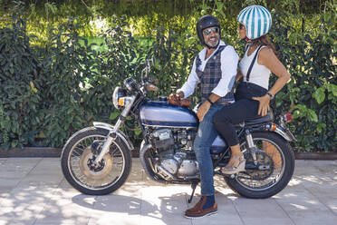 Happy mature couple on a vintage motorbike - DLTSF00248