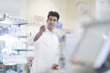 Pharmacist in a pharmacy with a tablet - CAVF65138