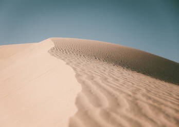 Ridge and blue sky at the sand dunes in the desert near Yuma, AZ - CAVF65151