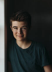 Portrait of a caucasian teenage boy against a dark background. - CAVF65244