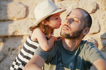 Little girl kissing her father at sunset - GEMF03223