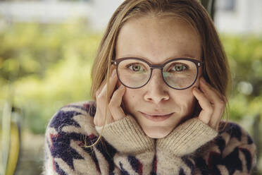 Portrait of young woman with glasses wearing fluffy sweater - MFF04880