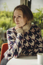 Young woman with glasses wearing fluffy sweater looking sideways - MFF04884