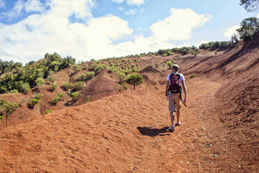 Hiker on red soil, Agulo, La Gomera, Canary Islands, Spain - MAMF00884