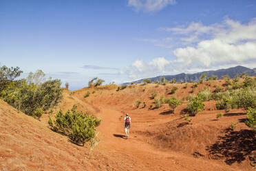 Hiker on red soil, Agulo, La Gomera, Canary Islands, Spain - MAMF00885