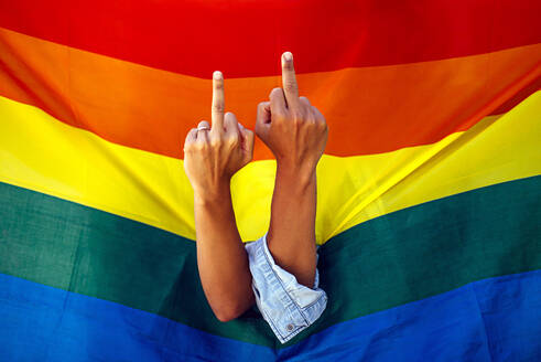 Two women giving the finger in front of a rainbow flag - OCMF00807