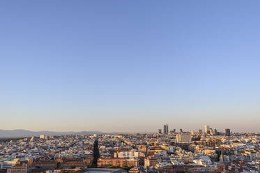 Spain, Madrid, Clear sky over city downtown at dusk - JCMF00244