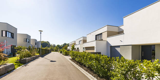 Germany, Bavaria, Neu-Ulm, Rows of suburb houses and empty street - WDF05521