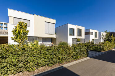 Germany, Bavaria, Neu-Ulm, Front yard hedges of suburb houses - WDF05523