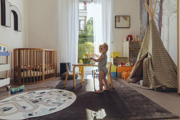 Baby boy playing in his nursery - MFF04928