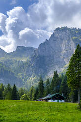 Germany, Bavaria, Arzbach, Scenic view of secluded Hintere Langentalalm cafe with Benediktenwand ridge in background - LBF02740