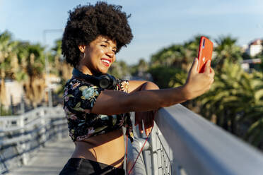 Lächelnde afroamerikanische Frau macht ein Selfie - ERRF01751