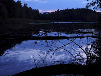 Germany, Bavaria, Shiny lake in Upper Palatine Forest at dusk - HUSF00100