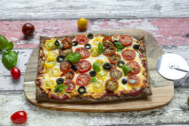 Low carb flax seed pizza with cheese, cherry tomatoes, olives and basil - SARF04384
