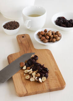 Cutting board with dried cherries and hazelnuts chopped for granola - EVGF03510