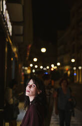 Portrait of a young woman in the city at night - LJF01072