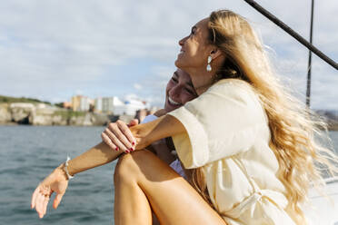 Two beautiful women enjoying a summer day on a sailboat - MGOF04148