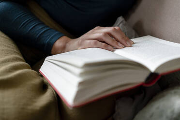 Woman reading novel, close-up - KNSF06840