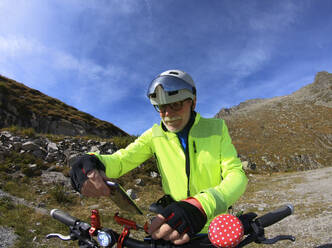 Senior man with his electric mountain bike in the Alps - LAF02384