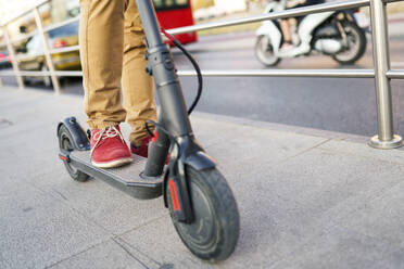 Man with electric scooter in the city, partial view - JSMF01359