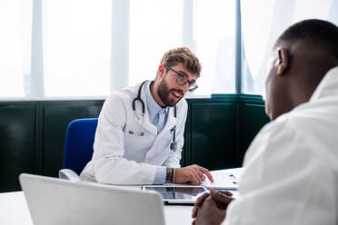 Doctors having discussion in meeting room - ISF22149