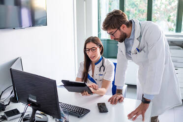 Doctor and nurse using digital tablet in hospital - ISF22166