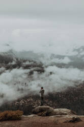 Hiker enjoying view of fog covering valley, Yosemite National Park, California, United States - ISF22313