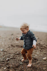 Toddler playing on beach - ISF22328