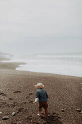 Toddler playing on beach - ISF22329