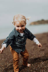 Toddler playing on beach - ISF22332