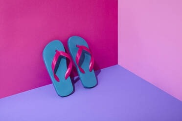 Pair of colourful flip-flops leaning on wall - ISF22449