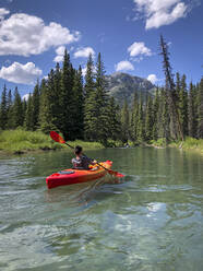 Teenage boy kayaking on Vermilion Lakes in Banff National Park. - CAVF65683