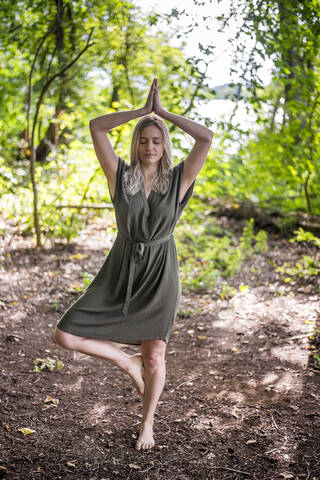 Woman meditating outdoors stock photo