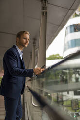 Young businessman with businessman on pedestrian bridge - MAUF02988