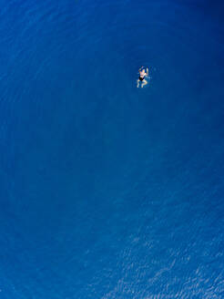 Luftaufnahme einer alten Frau beim Schwimmen im Meer in Spanien. - AAEF04498