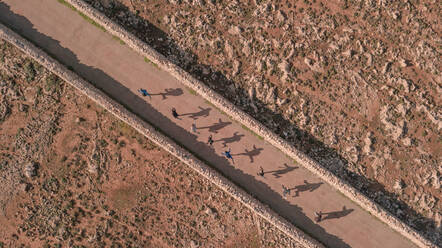 Aerial view of people and their shadows in Menorca, Balearic Islands, Spain. - AAEF04502