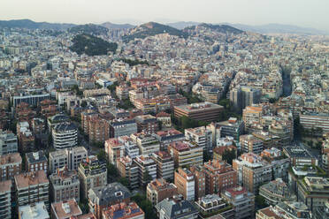 A view over Barcelona, Spain at sunset from a drone a few hundred feet above the city. - AAEF04559