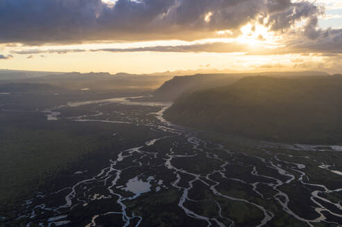 A sunset in mid summer over the glacial rivers that flow down to the ocean, Iceland. - AAEF04575