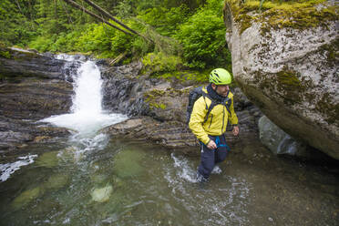 Hiker walks through canyon in British Columbia, Canada. - CAVF65772